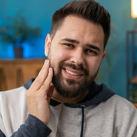 A man holding his face in pain
